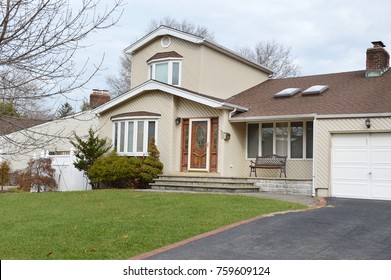 Tan Split Level Suburban Home Overcast Sky USA