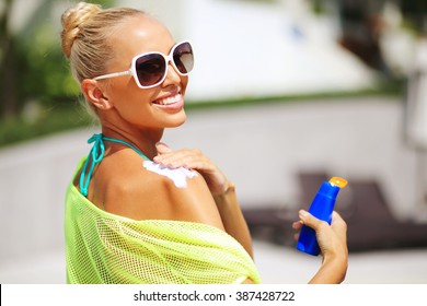 Tan Woman Applying Sun Protection Lotion