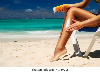 Tan Woman Applying Sun Protection Lotion