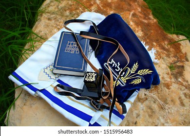 Tanah (Hebrew Bible), Tefillin (box with verses from the Torah) and Talit (prayer shawl). Translation from hebrew: Torah Neviim Ketuvim, Talit and put on the head