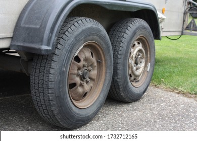 Tandem Axle With Rusty Rims Of A Car Trailer