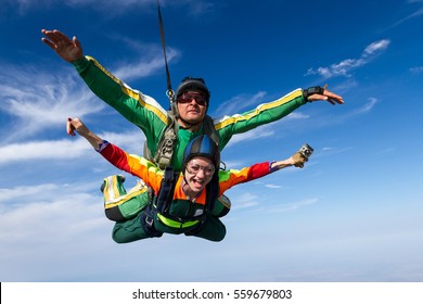 Tandem jump. The girl with the instructor in freefall.