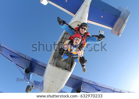 Tandem master and tandem passenger are jumping out of a plane.