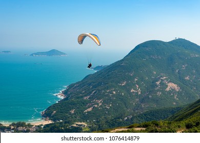 Tandem Paragliders Having Fun Paragliding Over Dragon's Back Hiking Trail In Hong Kong, Asia