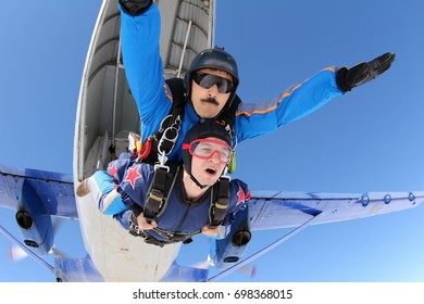 Tandem skydiving. Fist step in the sky.