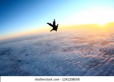 Tandem Skydiving, Flying Above The Earth During Sunset.