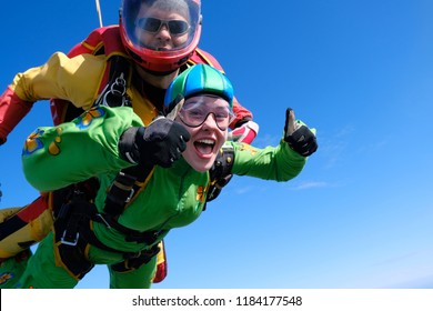 Tandem skydiving. Jump with pretty girl.