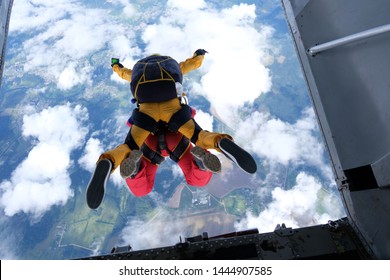 Tandem skydiving. Skydivers are jumping out of a plane.
