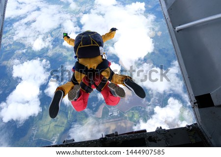 Tandem skydiving. Skydivers are jumping out of a plane.