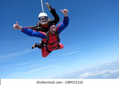 Tandem skydiving. Two men are flying in the sky.