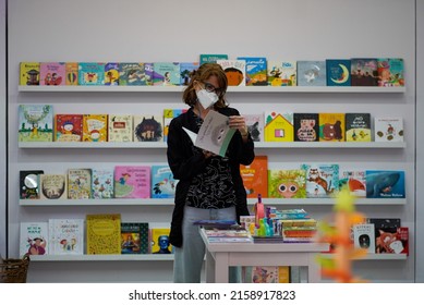 TANDIL, ARGENTINA - Feb 07, 2022: A Woman Reading A Book Inside A Children's Bookstore