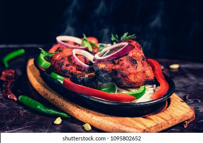 Tandoori chicken is chicken dish prepared by roasting chicken marinated in yoghurt and spices in a tandoor, a cylindrical clay oven. It is a popular dish from the Indian.