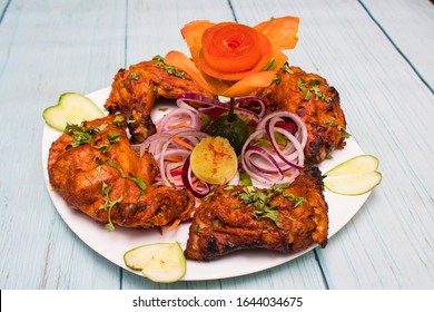 Tandoori chicken is a chicken dish prepared by roasting chicken marinated in yoghurt and spices in a tandoor. The origin of the dish is British Indian and popular all over India mostly North India