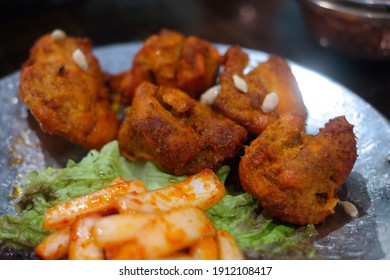 Tandoori chicken is an Indian chicken dish baked in a traditional, cylindrical oven made of mud called tandoor with marinated chicken in a spice-added yogurt.