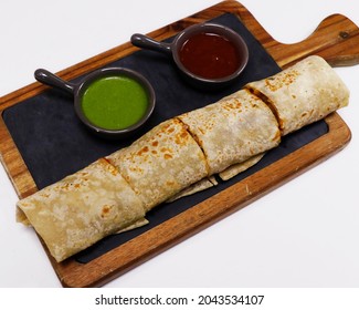 tandoori chicken tikka wrap sandwich served with mint and tamarind chutney, indian street food	