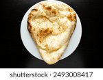 Tandoori Garlic Naan, nan, nun, bread or roti served in dish isolated dark background top view of indian spices, bangladeshi and pakistani food