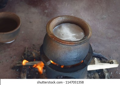 Tangalle, Sri Lanka - April 14, 2018: Buddhists and Hindus of Sri Lanka celebrate Avurudu, New Year's Day, by boiling milk in a new earthen pot and allowing it to boil over to bring prosperity.