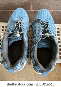Tangerang, Banten, Indonesia - October, 11, 2021 : Close up of blue Diadora sports shoes on a grey rack.