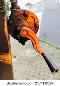 Tangerang, Indonesia. July 2 2022: Close Up Dirty Crank Pump That Is Wired To A Block Of Wood