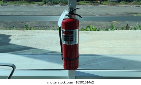 Tangerang, Jakarta - August 10,2020:Fire Extinguisher On Glass Wall

