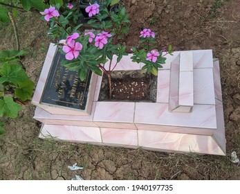 Tangerang,Indonesia, 21 Maret 2021.a Beautiful Muslim Baby Grave, Decorated With Ornamental Plants And Ceramics In Pink To White