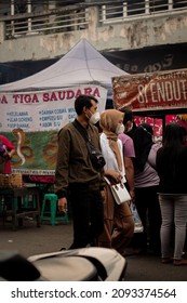 Tangerang-Indonesia,19-December-2021. A Pair Of Lovers Walking Together In The Culinary Tourism Area Of ​​​​the Old Market Of Tangerang