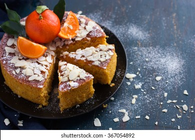 Tangerine And Almond Cake On Dark Blue Background, Selective Focus