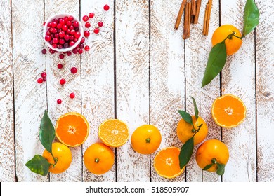 Tangerine, Cinnamon And Cranberries On White Wooden Table. Christmas Cooking.  Top View 