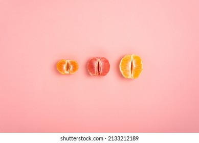 tangerine, grapefruit and orange cut in half on a peach background as a symbol of the vagina and female fertility, no people