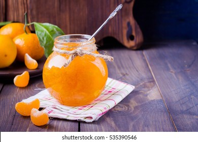 Tangerine jam in glass jar on the wooden table background - Shutterstock ID 535390546