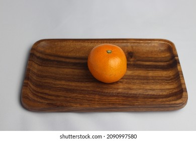 Tangerine On A Wooden Tray. White Background, Wooden Tray, Tangerine. Winter Fruit.