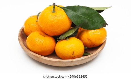 Tangerines. Close view on Fresh Mandarin Orange. Mandarin Imperial Ponkam, in woven basket. Green Leaf. Isolated on White Background. Citrus. Sweet an - Powered by Shutterstock