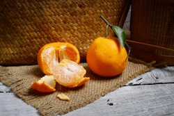 Tangerines Or Mandarin Oranges (Citrus Reticulata) Are Oranges That Can Grow In Tropical And Subtropical Areas, Randomly Some Are Whole, Some Have Been Cut, With A Natural Wood And Woven Background