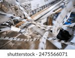 A tangle of metal industrial electric wiring near a computer system. Jumbled messy wires. Unsightly electric wires causing danger to health and safety.