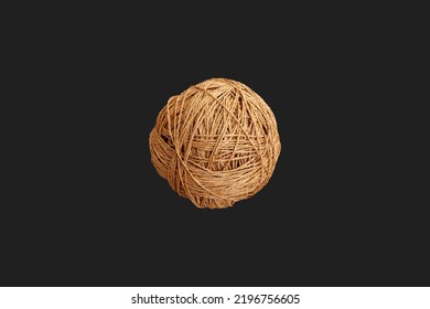 Tangle of rope yarn on dark background isolated. Straw color knitted ball.