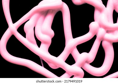 Tangle Of Stream Of Liquid Silicone On A Black Background