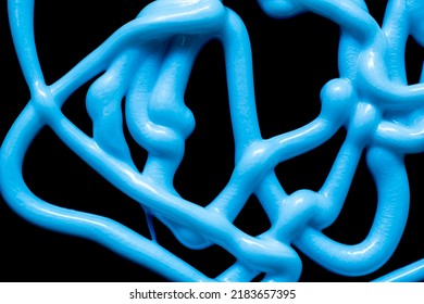 Tangle Of Stream Of Liquid Silicone On A Black Background