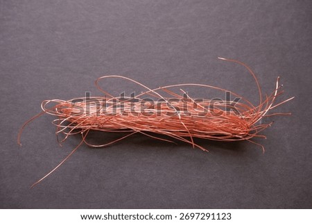 A tangled ball of bare copper wire