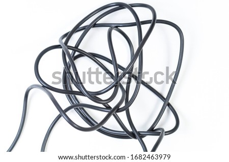 tangled black wire on a white background, selective focus