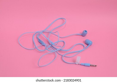 Tangled Earphones Wire On A Pink Background