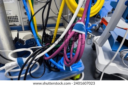 tangled electrical cords, a chaotic and complex network, symbolizing connection and technological mess