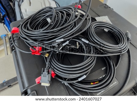 tangled electrical cords, a chaotic and complex network, symbolizing connection and technological mess