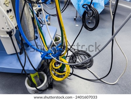 tangled electrical cords, a chaotic and complex network, symbolizing connection and technological mess