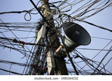 
Tangled Electrical Wires, Telephone Cables And Loudspeaker Pole