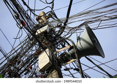 Tangled Electrical Wires, Telephone Cables And Loudspeaker Pole