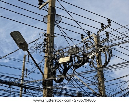 Tangled Mess of Overhead Power Lines and Cables with Street Light