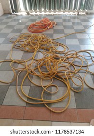 Tangled Plastic Hose On Tiled Floor