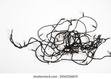 Tangled strings of Christmas lights on white background - Powered by Shutterstock