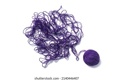 Tangled threads with a ball lie on a white background.
