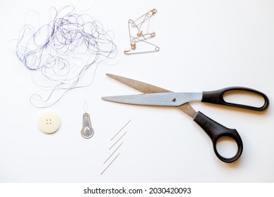 Tangled Threads, Needles, Threading, Safety Pins And Scissors Mockup Against White Background